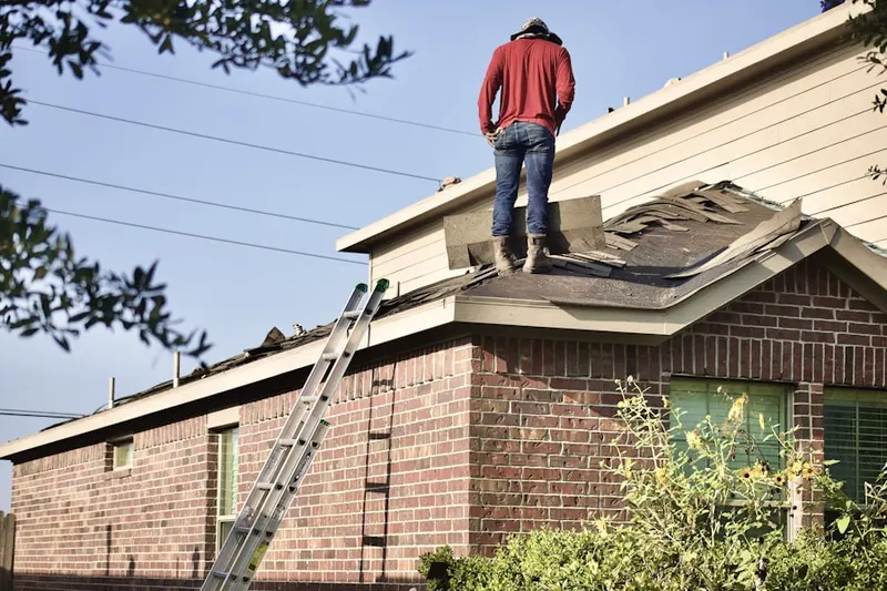 Professional roofer working on a residential roof in Fredericktown